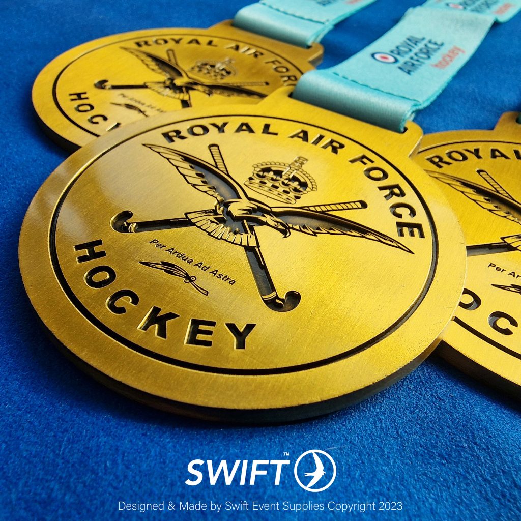 Close up image of RAF Hockey bespoke sports medals. Image shows recessed antique gold medals highest quality.